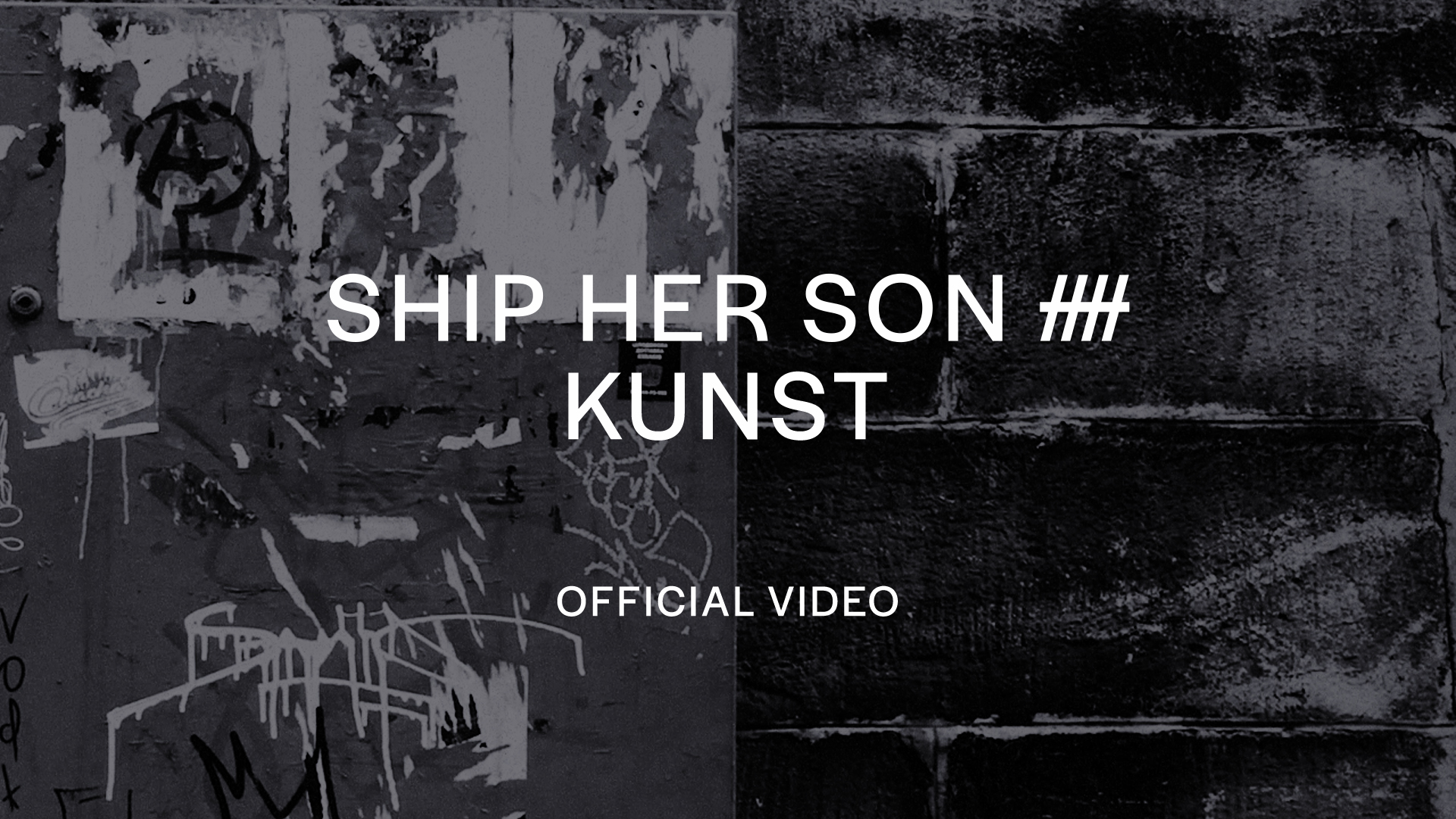 Kunst — torn posters on a graffitied brick wall, black and white